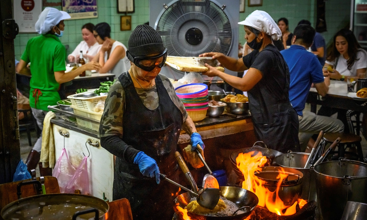 Michelin star chef Jei Fai cooks at her restaurant in downtown Bangkok on July 15, 2020. Photo: AFP