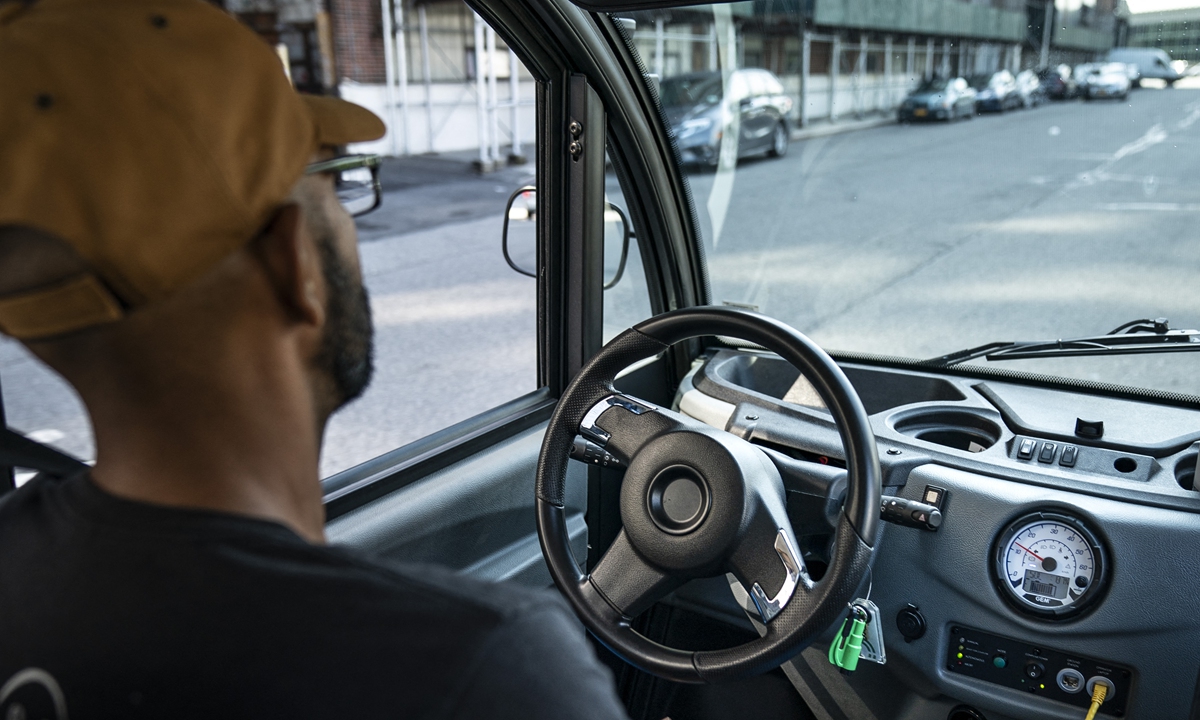 An Optimus Ride employee sits in the driver seat as he monitors the Optimus Ride autonomous six-seater shuttle bus as it drives through the Brooklyn Navy Yard on August 15, 2019 in New York City. Photo: AFP