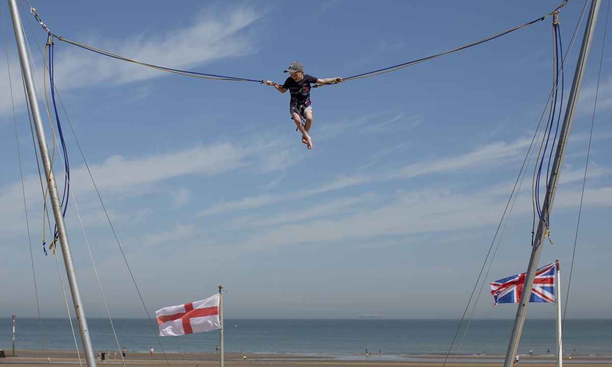 A boy enjoys an attraction on the seafront on June 2 in Margate. Photo: VCG