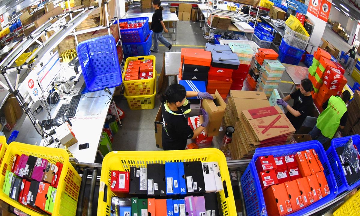 Staff at an industry zone in Lianyungang, East China's Jiangsu Province sort packages on Friday, the day China's major e-commerce platforms including JD and Alibaba's Tmall celebrate this year 618 mid-year shopping festival. Photo: VCG