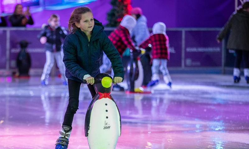 A girl skates on the Winter Festival at Darling Harbour in Sydney, Australia, on June 18, 2021.Photo:Xinhua