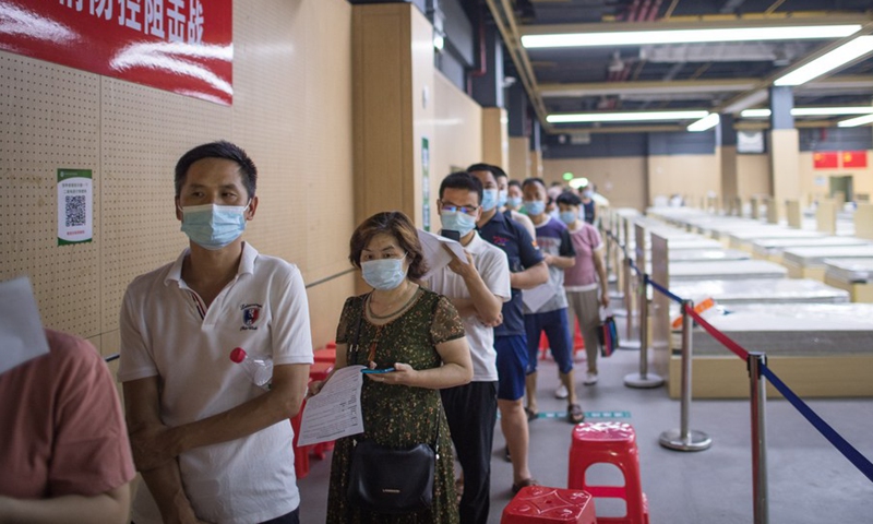People wearing face masks line up to receive the COVID-19 vaccines at a vaccination site in Jiangxia District in Wuhan, central China's Hubei Province, June 9, 2021.Photo: Xinhua