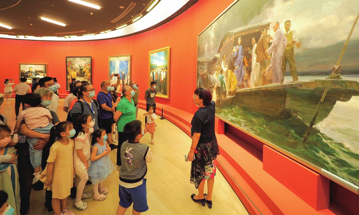 A guide explains a picture at a fine arts exhibition to celebrate the 100th founding anniversary of the Communist Party of China at the National Art Museum of China in Beijing on Sunday. Photo: cnsphoto