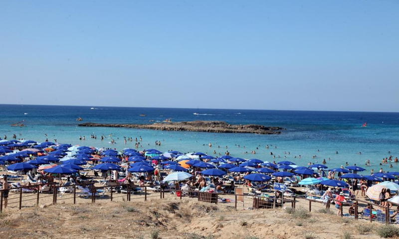 People enjoy themselves at the seaside in Protaras, Cyprus, on June 20, 2021. Most of the COVID-19 restrictions have been lifted in Cyprus.(Photo: Xinhua)