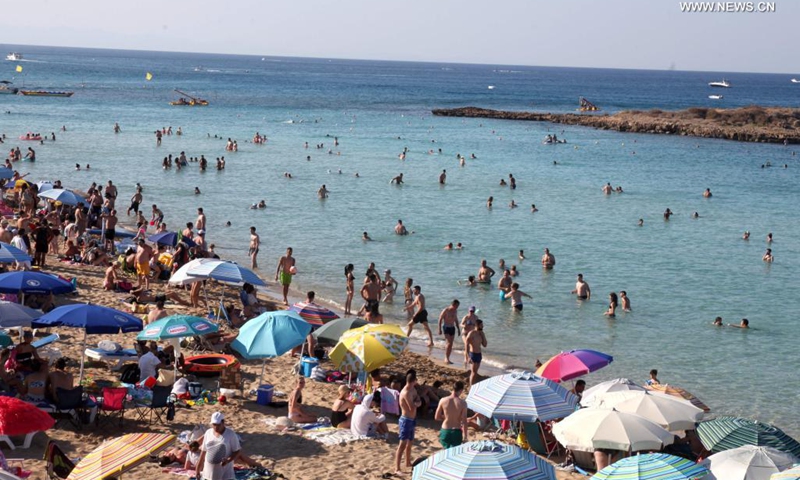 People enjoy themselves at the seaside in Protaras, Cyprus, on June 20, 2021. Most of the COVID-19 restrictions have been lifted in Cyprus.(Photo: Xinhua)