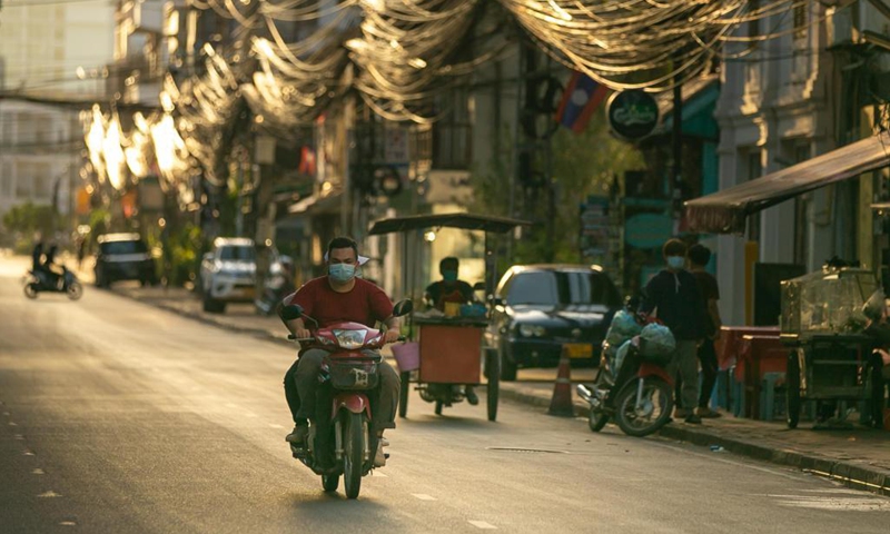 A motorcyclist wearing a face mask rides on a street in Vientiane, Laos, June 19, 2021. Laos has extended its lockdown COVID-19 prevention measures across the country for a further 15 days as the community spread of COVID-19 in the capital continues. (Photo: Xinhua)
