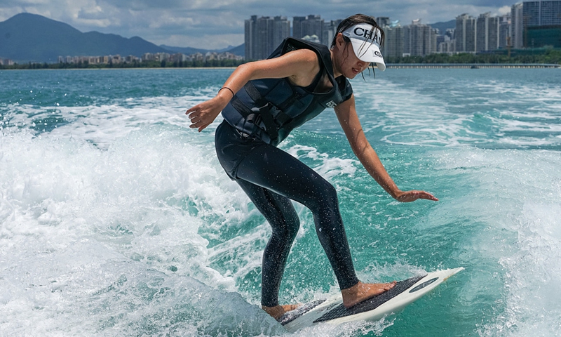 A tourist tries wake surfing on June 10, 2021 in Sanya, South China's Hainan Province. Photo: CFP