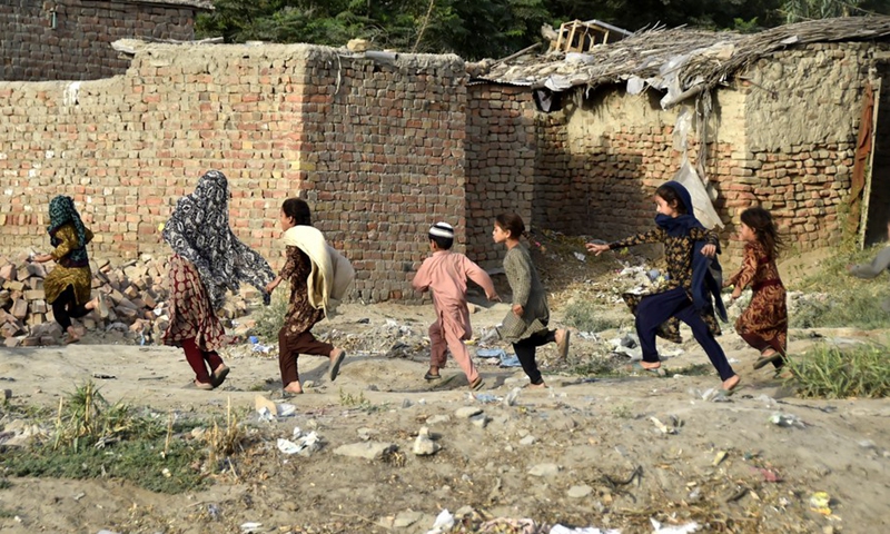Afghan refugee children play on the eve of the World Refugee Day on the outskirts of Peshawar, Pakistan, on June 19, 2021. (Photo: Xinhua)