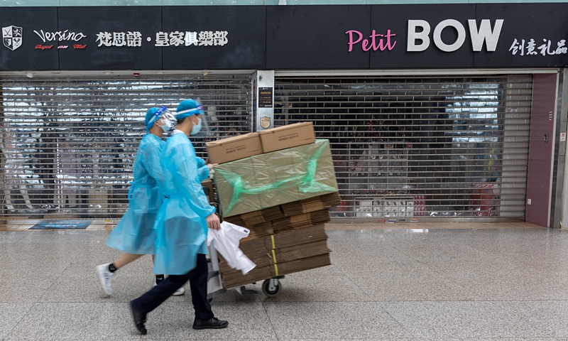 Airport employees pass by closed shops at Baoan International Airport, Shenzhen, South China's Guangdong Province on June 19, 2021. Photo: CFP