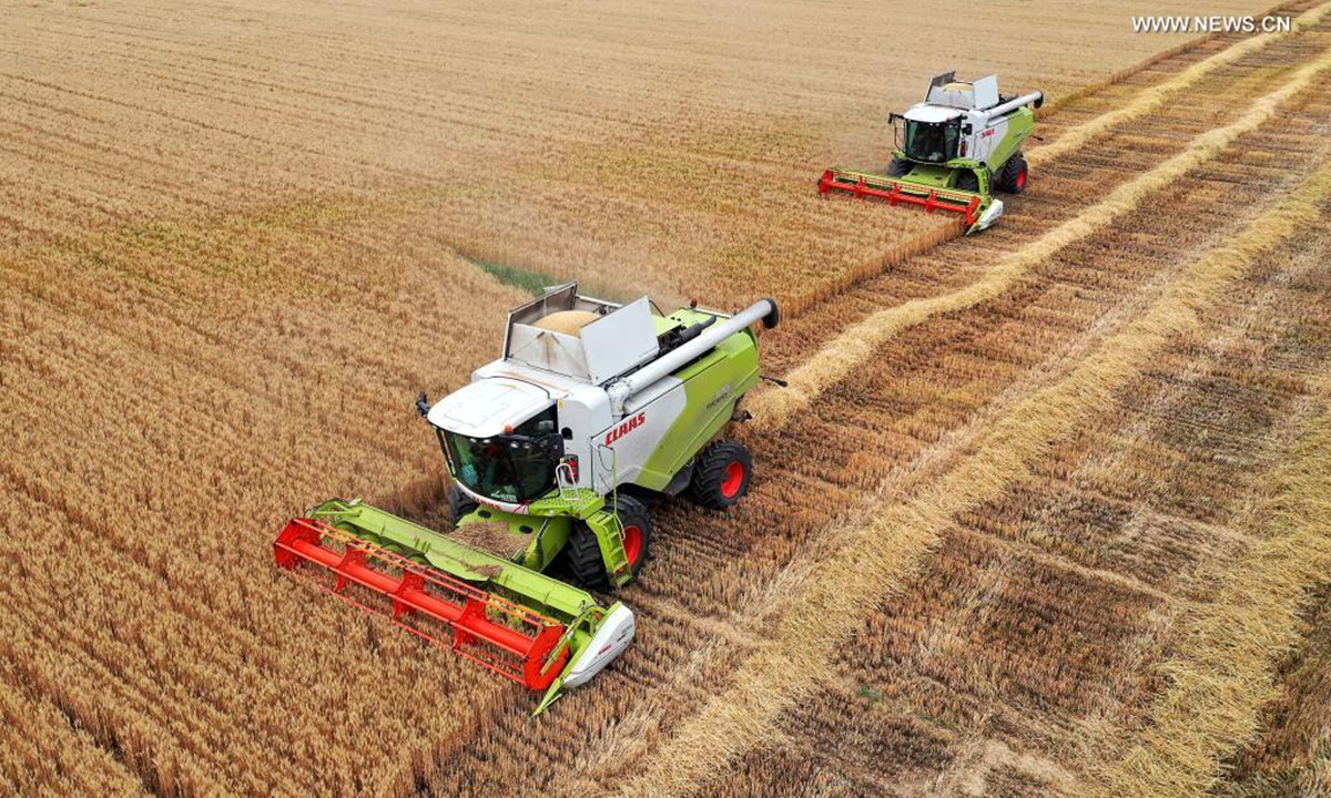 Reapers harvest wheat in the fields of Tancheng County, Linyi City, east China's Shandong Province, June 11, 2021. China reaped another bumper summer harvest in 2021, the country's agriculture minister said Wednesday.(Photo by Zhang Chunlei/Xinhua)