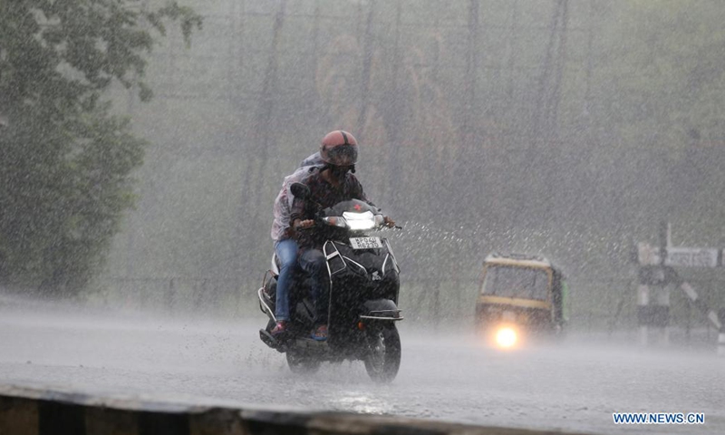 A man rides in a heavy rainfall in Bhopal, capital of India's Madhya Pradesh state, June 22, 2021. (Str/Xinhua)