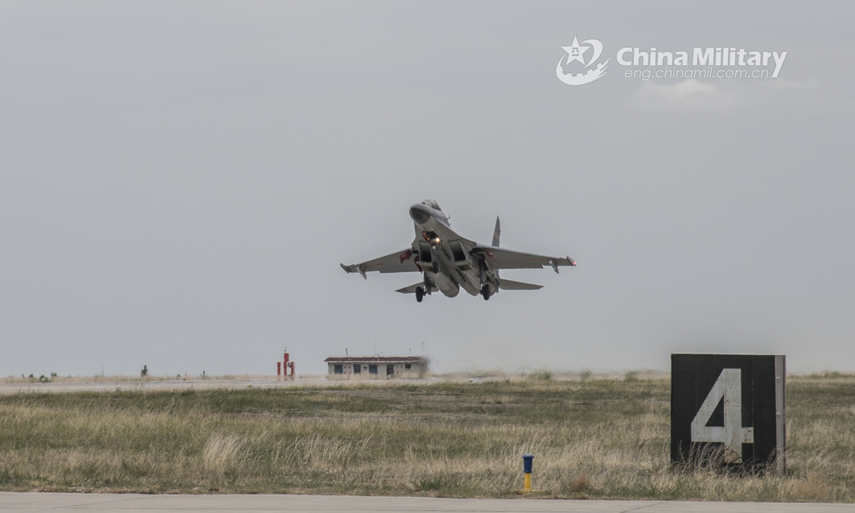 A fighter jet attached to an aviation brigade of the air force under the PLA Western Theater Command takes off from the runway during a flight training exercise on June 10, 2021. (eng.chinamil.com.cn/Photo by Cao Yukun)