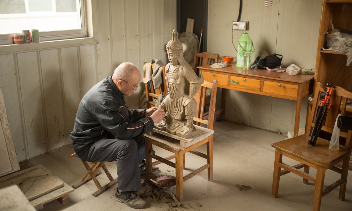 A senior sculptor makes a worrier statue at the Qufu Glazed Tile Factory Co Photo: Shan Jie/GT