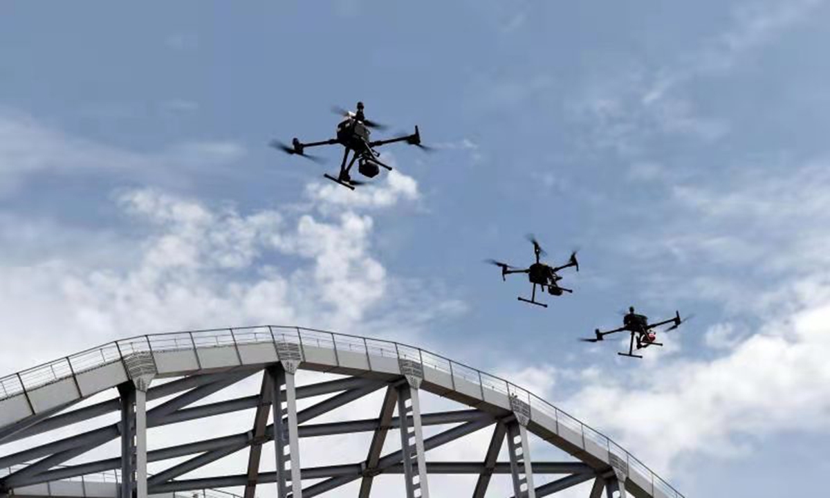 Three UAVs equipped with a high precision equipment patrol around the Jinan Yellow River Bridge to inspect its steel structure.