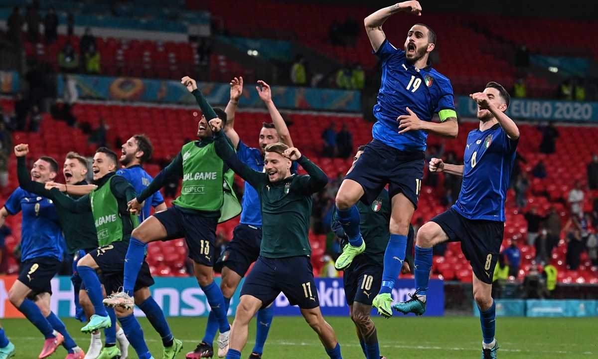 Italian players celebrate their win over Austria in London on Saturday. Photo: VCG
