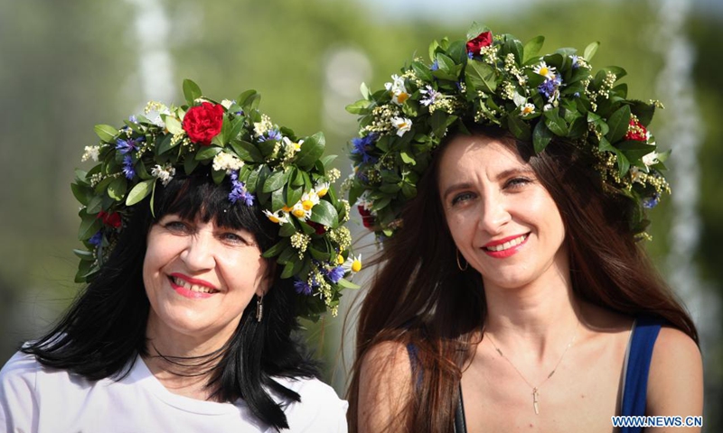 Women wearing traditional floral wreaths gather during the summer solstice celebrations in Warsaw, Poland, on June 26, 2021. (Photo: Xinhua)