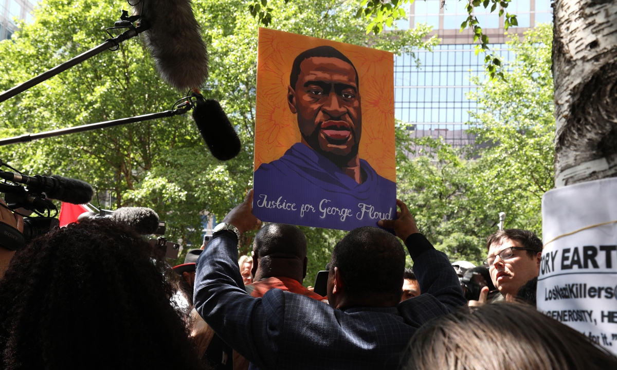 A demonstrator holds up an image of George Floyd following the sentencing of former Minneapolis police officer Derek Chauvin outside Hennepin County Government Center in Minneapolis, Minnesota, on Friday. Chauvin was sentenced to 22 years and six months in prison for murdering Floyd, a videotaped killing that triggered the most profound racial upheaval in the US since the civil rights era. Photo: VCG