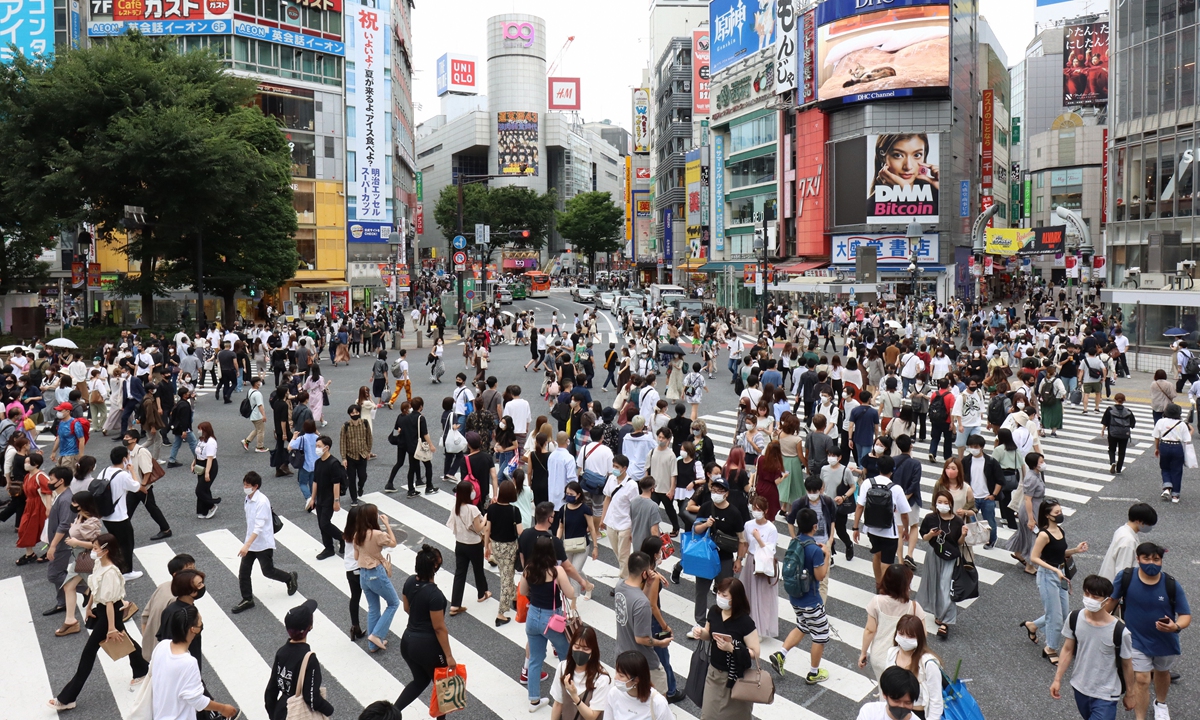 People walk across the Shibuya Scramble crossing in downt Tokyo on the first weekend after the COVID-19 state of emergency has been lifted on Saturday in Tokyo, Japan with the Tokyo Olympic Games only weeks away. Photo: VCG