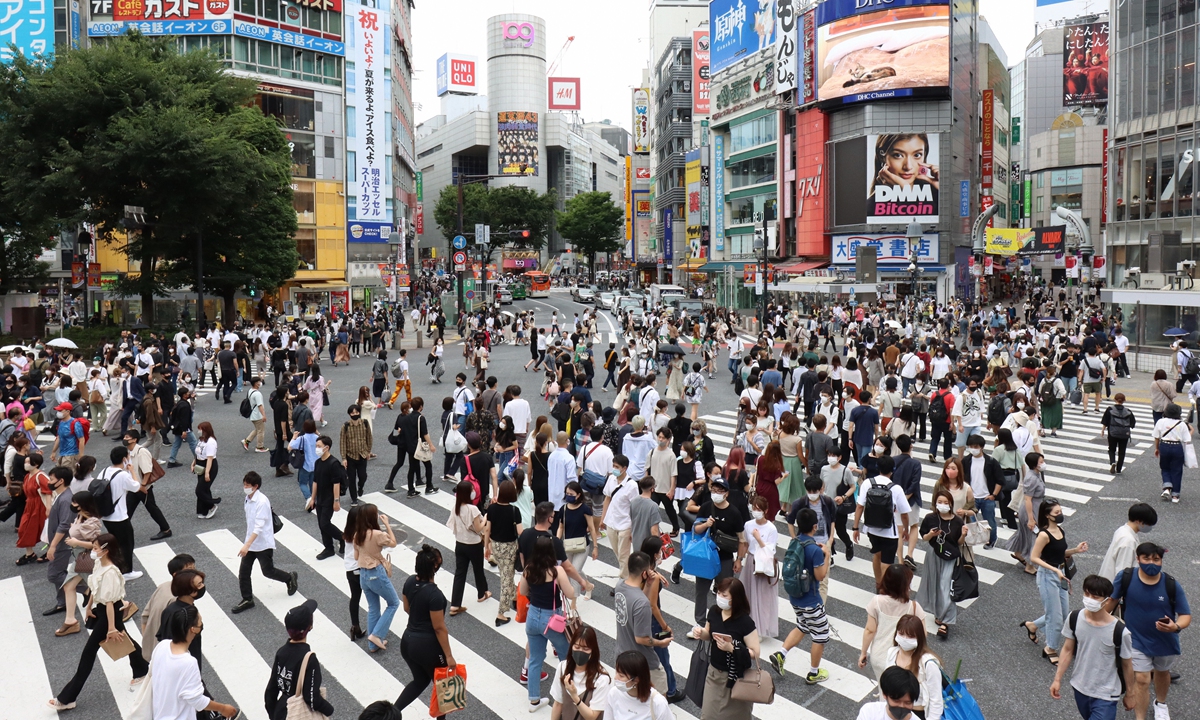 People walk across the Shibuya Scramble crossing in downt Tokyo on the first weekend after the COVID-19 state of emergency has been lifted on Saturday in Tokyo, Japan with the Tokyo Olympic Games only weeks away. Photo: VCG