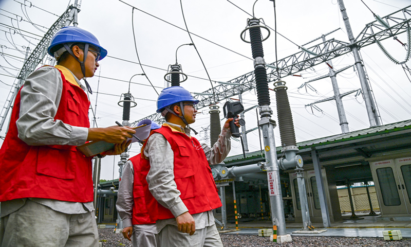 Workers check equipment at a power station in Jinhua, East China's Zhejiang Province on Monday to ensure stable operation. To meet high demand for power, China produced 3177 billion kilowatt-hours of electricity from January to May, up 14.9 percent year-on-year. Photo: VCG