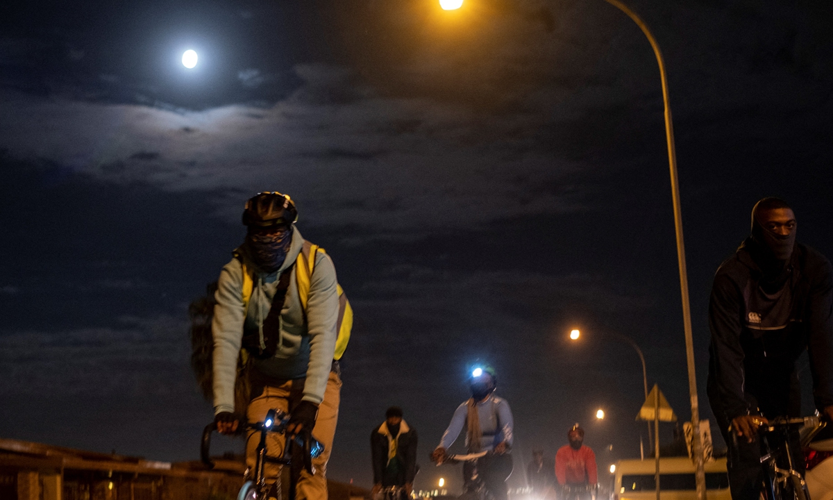 Tiyiselani Mashele (left), co-founder of Biking Bandits, cycles during the Homies Night Ride in Soweto, South Africa on Thursday. Photo: AFP