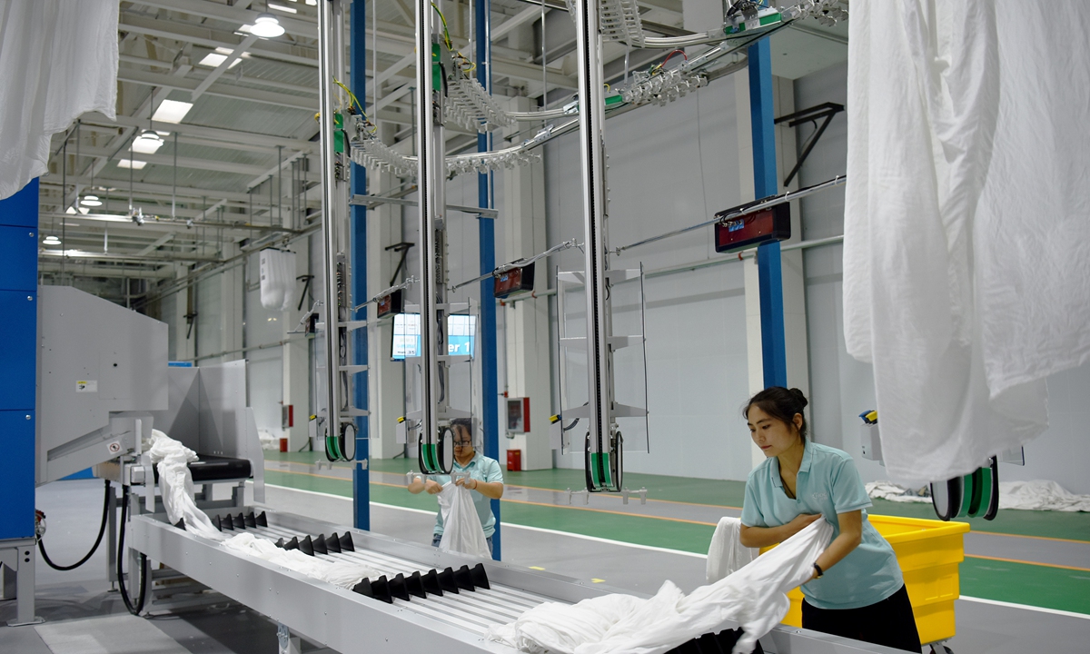 Employees work at the Huanxin Textile Washing Industrial Park, in Zhangjiakou, North China's Hebei Province, which opened on Monday. The park is set to serve the 2022 Beijing Winter Olympic Games with an integrated service including linen rental, washing and logistics. It will also provide washing and cleaning services for hotels, medical facilities, planes and high-speed trains in several places. Photo: VCG