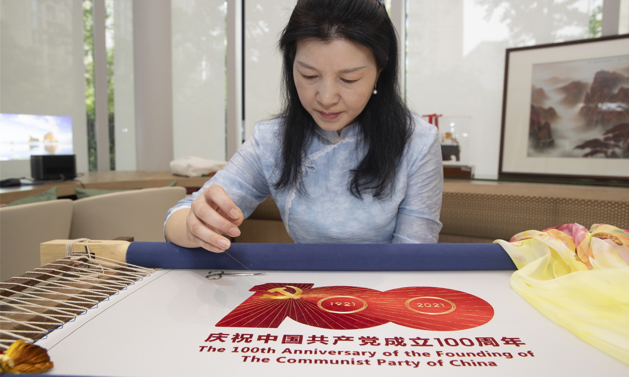 An artist embroides the celebration logo for the 100th anniversary of the founding of the CPC at a Party services center in Wuxi, East China's Jiangsu Province on June 19. Photo: cnsphoto