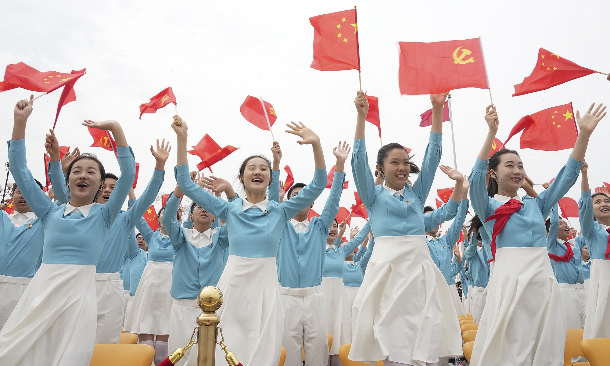 Representatives of the Chinese Communist Youth League and Young Pioneers wave the Chinese national flag and the flag of the Communist Party of China at a ceremony marking the CPC's centennial at Tian'anmen Square in Beijing on Thursday. Photo: Xinhua
