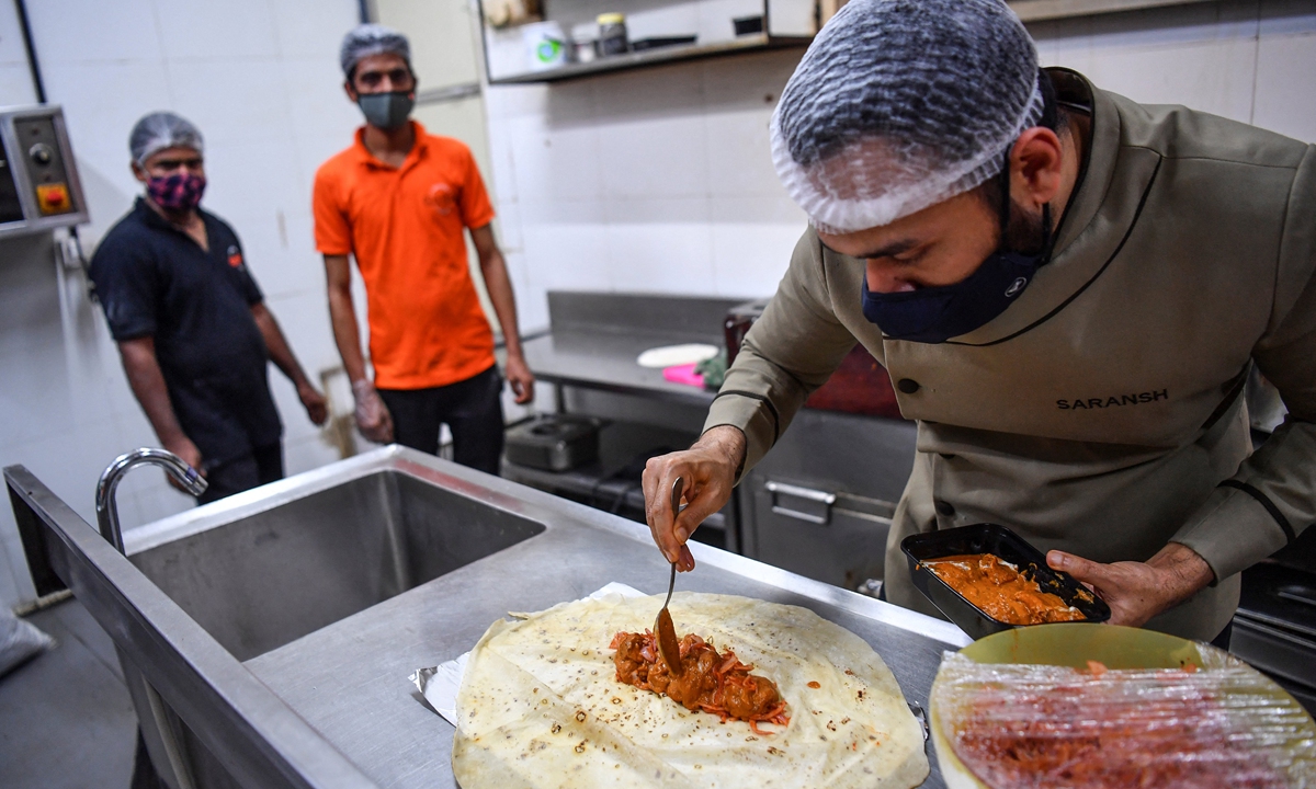 Chef Saransh Goila prepares an order at the Goila Butter Chicken restaurant kitchen in Mumbai on June 21. Photo: AFP