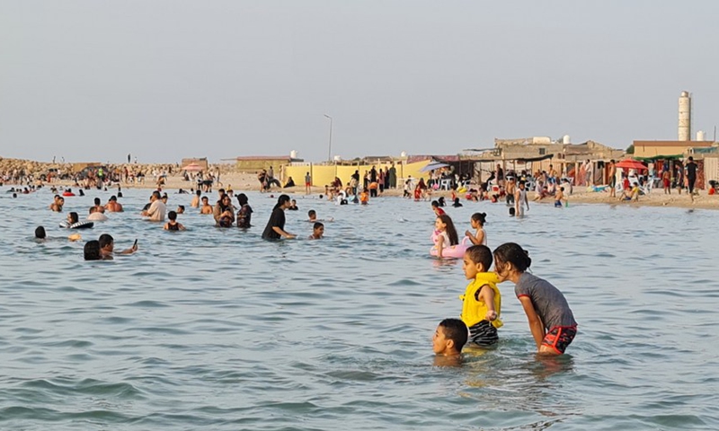 People cool off in the sea off Garrabulli town, some 55 km east of Tripoli, Libya, on June 29, 2021.(Photo: Xinhua)