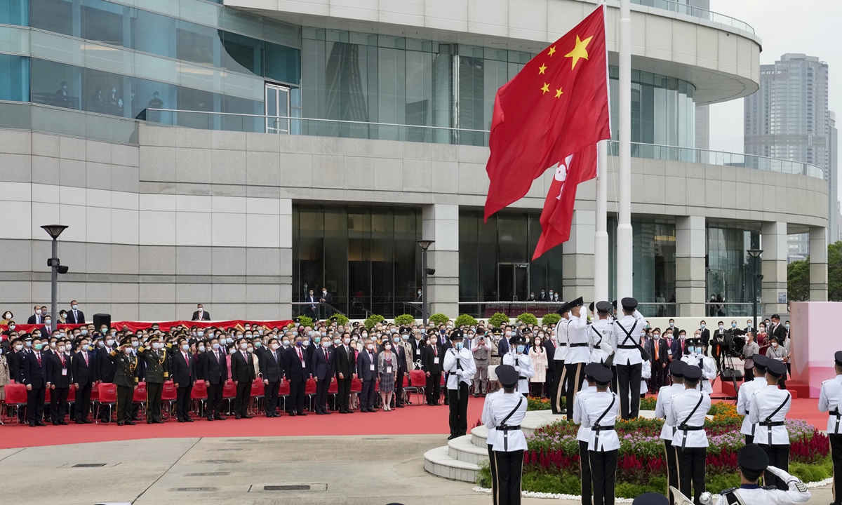 Officials from the Hong Kong Special Administrative Region attend a flag-raising ceremony at the Golden Bauhinia Square on Thursday to celebrate the 24th anniversary of the city's return to the motherland. Thursday also marked the 100th anniversary of the founding of the Communist Party of China. Photo: VCG