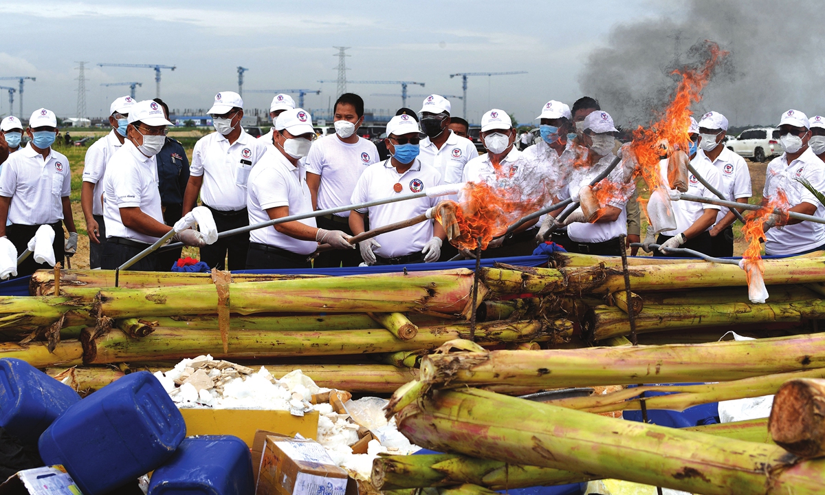Officials prepare to burn seized illegal drugs to mark the United Nations' special international day to fight drug abuse and illicit trafficking, during a ceremony in Phnom Penh on Monday. Photo: AFP
