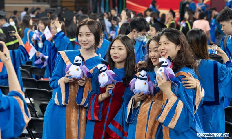Graduates take group photos during a graduation ceremony at Beijing Foreign Studies University (BFSU) in Beijing, capital of China, July 2, 2021. BFSU, a university well recognized in China for foreign language education, held a guaduation ceremony for its Class of 2021 graduates on Friday.Photo:Xinhua