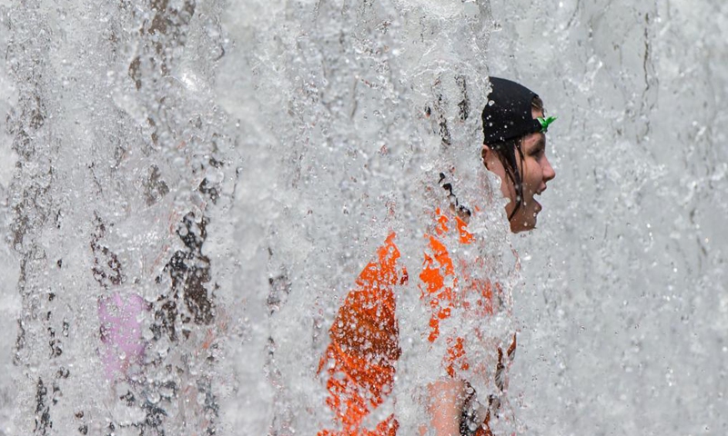 Children cool off in a fountain as hot and humid weather continues in Toronto, Canada, on July 1, 2021.Photo:Xinhua