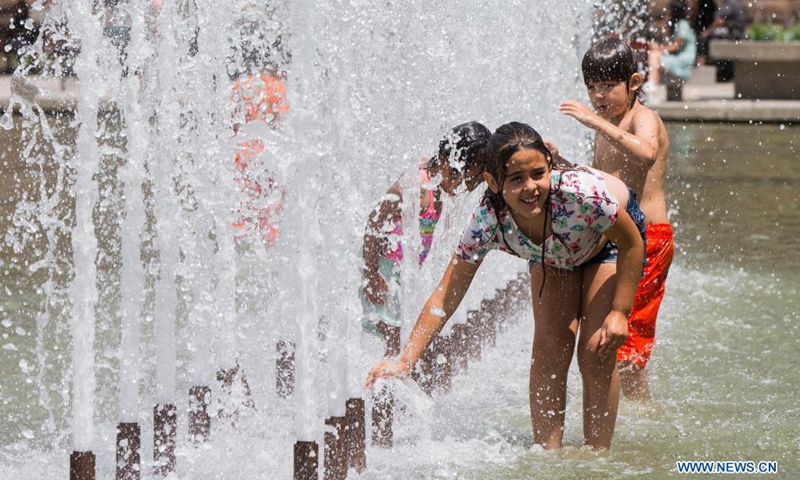 Children cool off in a fountain as hot and humid weather continues in Toronto, Canada, on July 1, 2021.Photo:Xinhua