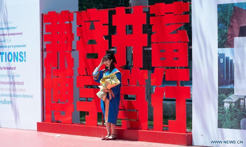 A graduate poses for a photo upon graduation at Beijing Foreign Studies University in Beijing (BFSU), capital of China, July 2, 2021. BFSU, a university well recognized in China for foreign language education, held a guaduation ceremony for its Class of 2021 graduates on Friday.Photo:Xinhua