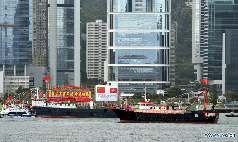 Fishing boats flying China's national flags and the flags of the Hong Kong Special Administrative Region (HKSAR) cruise at Victoria Harbour in Hong Kong, south China, July 1, 2021.Photo:Xinhua