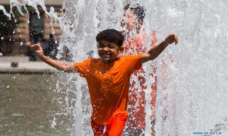 Children cool off in a fountain as hot and humid weather continues in Toronto, Canada, on July 1, 2021.Photo:Xinhua