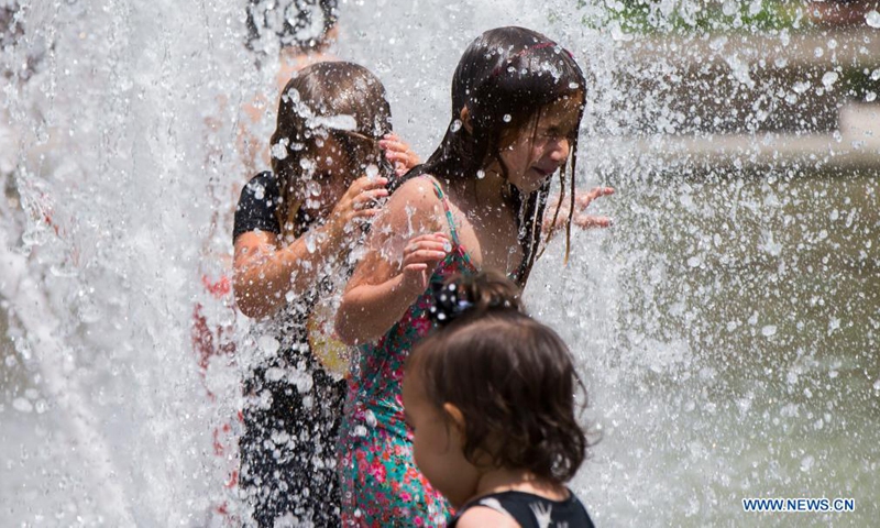 Children cool off in a fountain as hot and humid weather continues in Toronto, Canada, on July 1, 2021.Photo:Xinhua