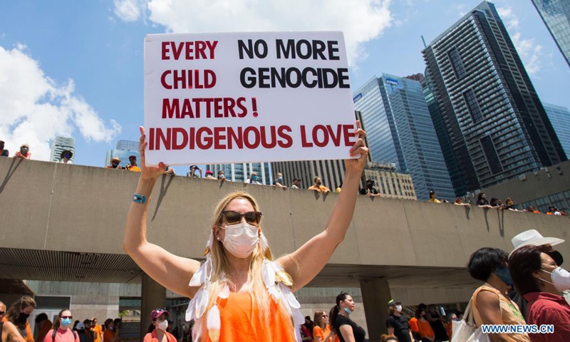 A woman holds a placard during a rally in Toronto, Canada, on July 1, 2021.Photo:Xinhua