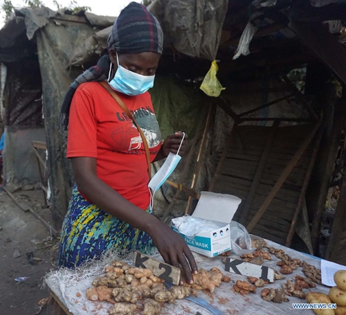 Naomi Kakoma, a 27-year-old trader at Lupili market, sells fresh ginger in Lusaka, Zambia, on June 27, 2021. Interactions with Lusaka-based traders revealed that spices with medicinal elements sales have more than doubled during the COVID-19 period and sellers are continuously running out of stock.(Photo: Xinhua)