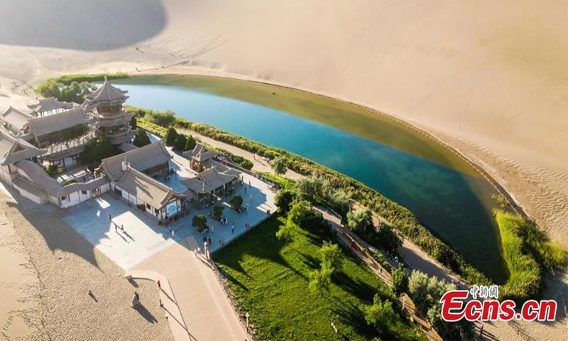 Photo taken at the beginning of July shows the Crescent Lake in Dunhuang, Gansu Province turns green and fresh in the desert after several raining days. The precipitation has increased in Dunhuang this year, making the Crescent Lake much picturesque. (Photo/ Wang Binyin)