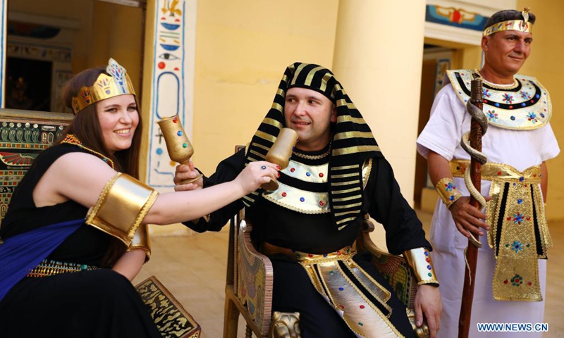 People wearing pharaonic costumes take part in a pharaonic wedding ceremony held to revitalize tourism affected by the COVID-19 pandemic at Pharaonic Village in Giza, Egypt, on July 5, 2021.(Photo: Xinhua)