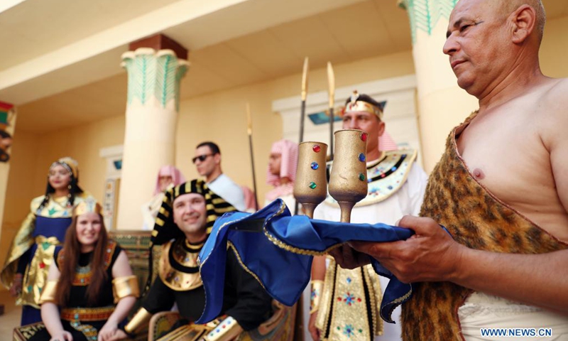 People wearing pharaonic costumes take part in a pharaonic wedding ceremony held to revitalize tourism affected by the COVID-19 pandemic at Pharaonic Village in Giza, Egypt, on July 5, 2021.(Photo: Xinhua)
