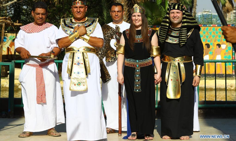 People wearing pharaonic costumes take part in a pharaonic wedding ceremony held to revitalize tourism affected by the COVID-19 pandemic at Pharaonic Village in Giza, Egypt, on July 5, 2021.(Photo: Xinhua)