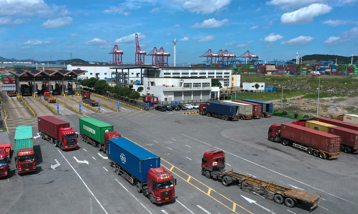 Container carriers run into Zhoushan Yongzhou Container Terminals at the Ningbo Zhoushan Port in East China's Zhejiang Province on Tuesday. According to local customs data, Zhoushan Yongzhou handled 21,290 standard containers by overland routes in the first half, surging 3,417% year-on-year. Many shippers opted for land routes instead of water, partly because of lower costs. Photo: cnsphoto