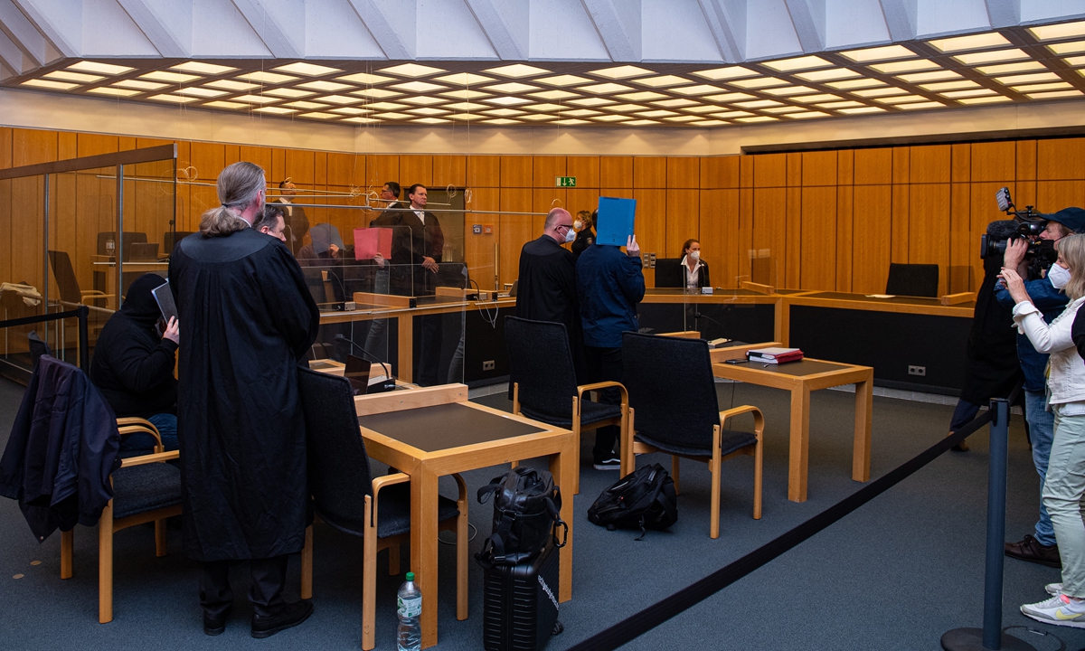The defendants hide their faces behind folders as they arrive for their judgments in a child sex abuse case at court in Munster, northwestern Germany, on Monday. The four ringleaders of one of the biggest child sex abuse rings in Germany were jailed for between 10-14 years. Some 50 people have been linked to the ring, with 30 already arrested. Photo: AFP