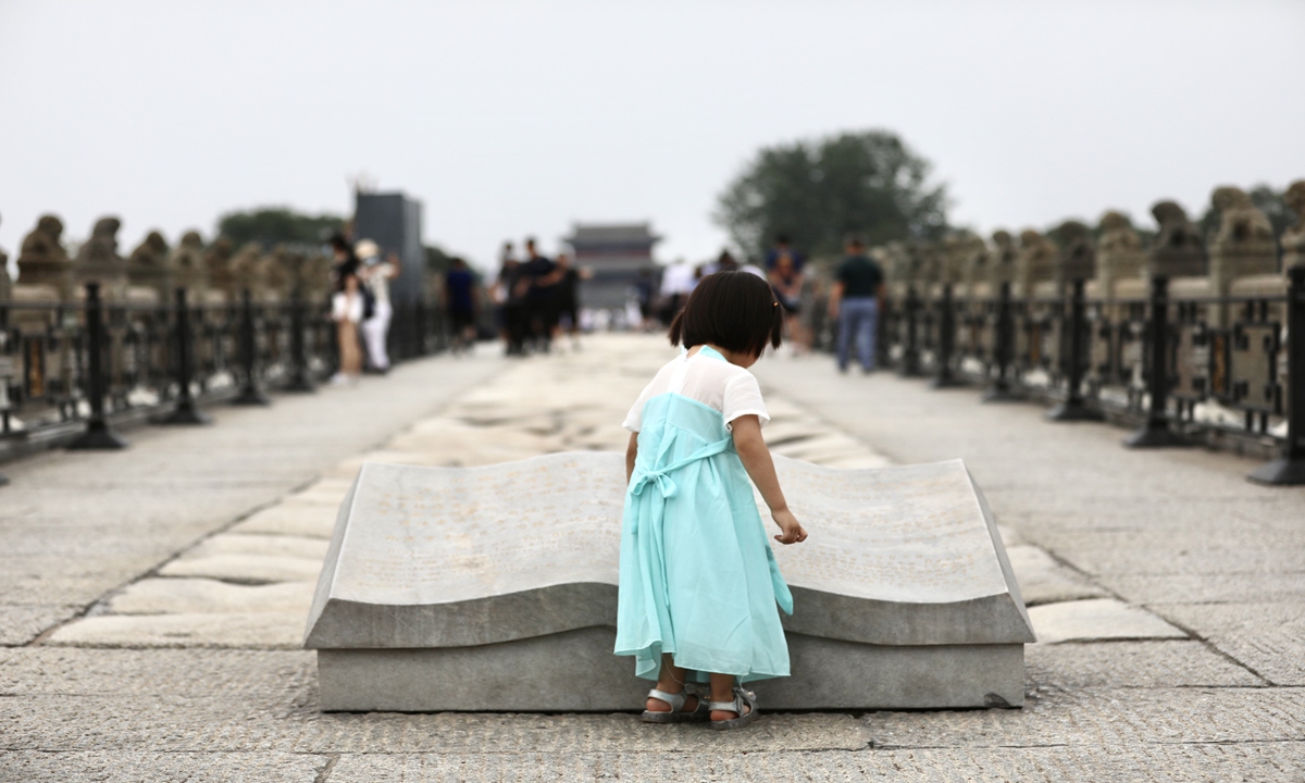 A young girl stands on Lugou Bridge in Beijing on Wednesday, which marks the 84th anniversary of the Lugou Bridge Incident taking place on July 7, 1937, considered the start of Chinese people's all-out War of Resistance against Japanese Aggression (1931-45). Photo: IC