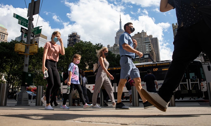 People walk on street in New York, the United States, June 15, 2021.(Photo: Xinhua)