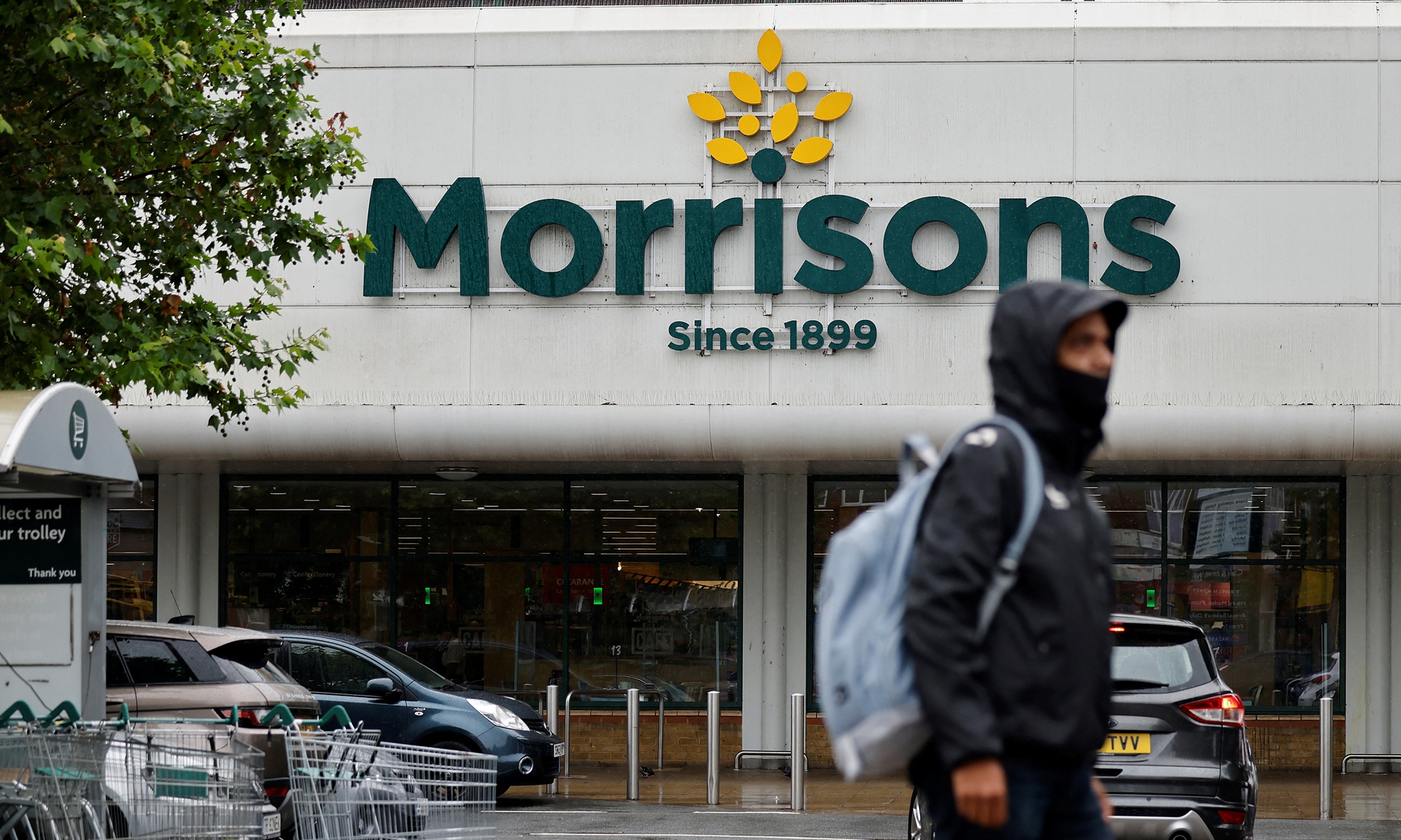 A man walks past a Morrisons supermarket in Stratford, east London on June 21. Photo: AFP